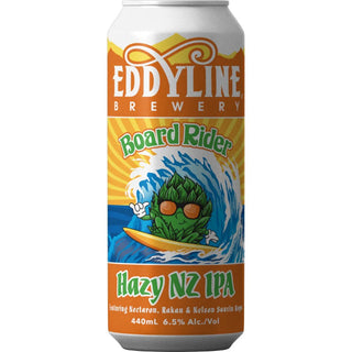A can of Eddyline Board Rider Hazy IPA with a colorful label featuring a cartoon of a character surfing on a wave, indicating it is a New Zealand beer with 6.5% ABV.